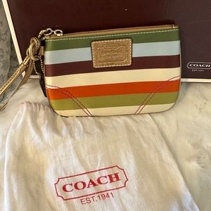 Coach striped multicolored wristlet. New. Comes with the dust-bag